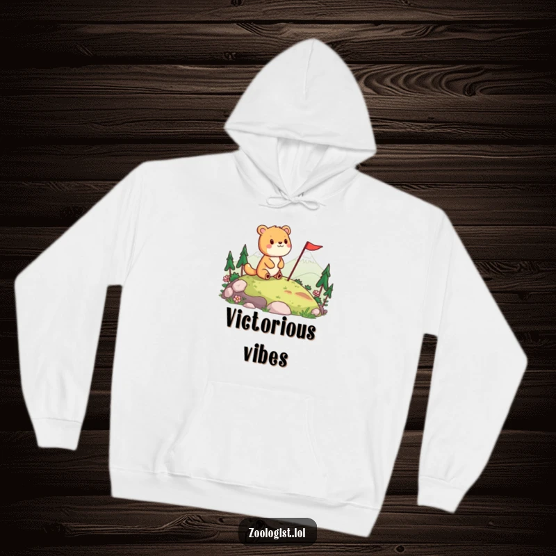 Funny hoodie with a cheerful animal surveying a landscape and planting a flag, blending warmth with humorous celebration.
