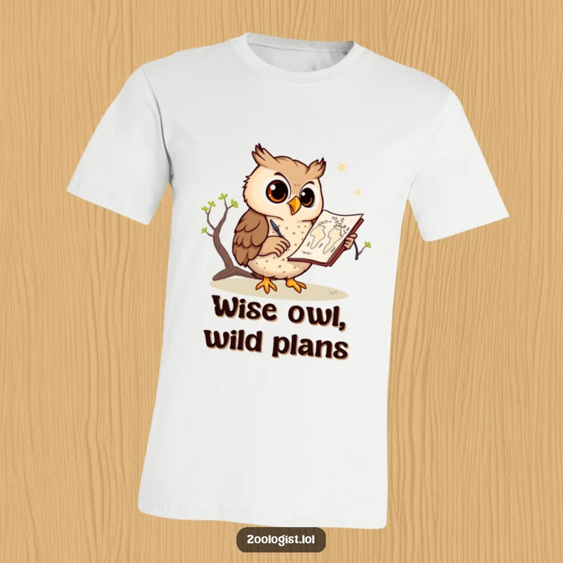 Funny owl t-shirt, a happy owl with a pencil sketching a detailed savanna map, conveying creativity and adventure, great for art enthusiasts.